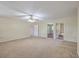 Bright living room with multiple doorways and neutral carpet, creating an open and inviting atmosphere at 106 Mayrant St, Summerville, SC 29483