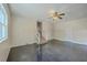 Bright living room with sleek floor, ceiling fan, and stairs to a bonus room at 106 Mayrant St, Summerville, SC 29483