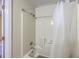 Clean shower-tub combination features a white shower curtain and neutral-toned surround at 106 Mayrant St, Summerville, SC 29483