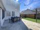 Backyard patio with outdoor dining set and string lights along the home's exterior at 107 Hainsworth Dr, North Charleston, SC 29418