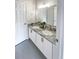 Well-lit bathroom with double sinks, granite countertop, and white cabinets at 107 Hainsworth Dr, North Charleston, SC 29418