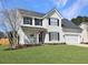 Charming two-story home with vinyl siding, a well-manicured lawn, and an attached two car garage at 107 Hainsworth Dr, North Charleston, SC 29418