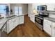 A modern kitchen featuring granite countertops, stainless steel appliances, and a double sink with hardwood floors at 107 Hainsworth Dr, North Charleston, SC 29418