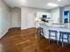 Bright open kitchen with granite counters, stainless appliances, an island, and hardwood floors with barstool seating at 107 Hainsworth Dr, North Charleston, SC 29418