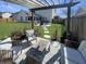 Cozy patio space with a wooden pergola, comfortable seating, and a well-maintained lawn for outdoor living at 107 Hainsworth Dr, North Charleston, SC 29418