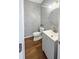 This powder room features stylish wallpaper, a modern vanity, and hardwood floors at 107 Hainsworth Dr, North Charleston, SC 29418