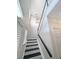 An interior view of a staircase with black steps and railing, leading up to the second floor at 107 Hainsworth Dr, North Charleston, SC 29418