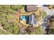 Aerial view of the home featuring a backyard pool, deck, firepit, and lush landscaping at 1104 Old Course Ln, Mount Pleasant, SC 29466
