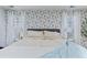 Bright bedroom with unique floral wallpaper, large bed, bedside tables and lamps at 1104 Old Course Ln, Mount Pleasant, SC 29466