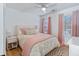 Bedroom with a comfortable bed, a white ceiling fan, wood floors and soft, pink accents at 1104 Old Course Ln, Mount Pleasant, SC 29466