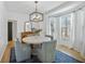 Bright dining room with bay window, stylish light fixture, and views of the outdoors at 1104 Old Course Ln, Mount Pleasant, SC 29466