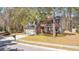 Beautiful two-story brick home with a well-manicured lawn and mature trees at 1104 Old Course Ln, Mount Pleasant, SC 29466