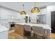 Open kitchen features stainless steel appliances, island with bar seating, and pendant lighting at 1104 Old Course Ln, Mount Pleasant, SC 29466