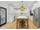Modern kitchen with white cabinets, stainless steel appliances, and a large central island at 1104 Old Course Ln, Mount Pleasant, SC 29466