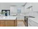 Bright kitchen features white cabinets, modern appliances, quartz countertops and wood flooring at 1104 Old Course Ln, Mount Pleasant, SC 29466