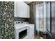 Laundry room with modern washer and dryer, stylish floral wallpaper and ample natural light at 1104 Old Course Ln, Mount Pleasant, SC 29466
