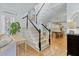 Open-concept living area with staircase, hardwood floors, and view into the kitchen at 1104 Old Course Ln, Mount Pleasant, SC 29466
