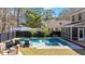 An aerial view shows the pool, spa, outdoor furniture and screened in porch in this private backyard oasis at 1104 Old Course Ln, Mount Pleasant, SC 29466