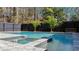 A stunning backyard pool features a spa, stone patio, and tropical landscaping for a relaxing outdoor oasis at 1104 Old Course Ln, Mount Pleasant, SC 29466