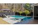 Relaxing backyard features a gorgeous pool, spa, lounge chairs and umbrella to enjoy the backyard oasis at 1104 Old Course Ln, Mount Pleasant, SC 29466