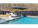 Backyard pool features a spa, lounge chairs and an umbrella to enjoy the outdoor space at 1104 Old Course Ln, Mount Pleasant, SC 29466