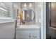 Cozy powder room features a round mirror, updated fixtures, and shiplap walls at 1104 Old Course Ln, Mount Pleasant, SC 29466