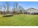 Large backyard with lush green grass and a trampoline, offering ample space for outdoor activities at 1114 Donerail Ln, Johns Island, SC 29455