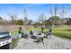Outdoor firepit surrounded by chairs and a grill for gatherings in a spacious and grassy fenced yard at 1114 Donerail Ln, Johns Island, SC 29455