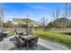 Backyard patio featuring an outdoor dining set, grill, and lounge area surrounded by a green lawn at 1114 Donerail Ln, Johns Island, SC 29455