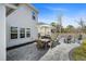 Spacious backyard patio with a dining table, chairs, and a fire pit, ideal for outdoor gatherings at 1114 Donerail Ln, Johns Island, SC 29455