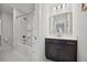 Bathroom featuring a shower/tub combo with white tile surround, modern lighting, and dark vanity at 1114 Donerail Ln, Johns Island, SC 29455