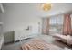 Bright bedroom featuring two twin beds, a dresser, neutral decor, and a window with light-filtering blinds at 1114 Donerail Ln, Johns Island, SC 29455