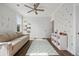Bright bedroom with a ceiling fan, a polka dot accent wall and wood flooring at 1114 Donerail Ln, Johns Island, SC 29455