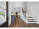 Bright entryway with hardwood floors, staircase, and view into the living room at 1114 Donerail Ln, Johns Island, SC 29455