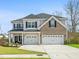 Charming two-story home with a well-manicured lawn and a two-car garage at 1114 Donerail Ln, Johns Island, SC 29455
