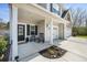 Inviting front porch with rocking chairs, leading to a two-story home with a two-car garage at 1114 Donerail Ln, Johns Island, SC 29455