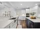 Well-lit kitchen area with an undermount sink, dark island, built in oven, and stainless steel appliances at 1114 Donerail Ln, Johns Island, SC 29455