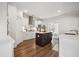 Modern kitchen with stainless steel appliances, white cabinets, dark wood island, and hardwood flooring at 1114 Donerail Ln, Johns Island, SC 29455