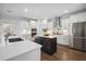 Bright kitchen features white cabinetry, a dark wood island with quartz countertops, and stainless steel appliances at 1114 Donerail Ln, Johns Island, SC 29455