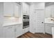 Modern kitchen with white cabinets, stainless steel built-in oven, and hardwood floors at 1114 Donerail Ln, Johns Island, SC 29455