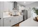 Well-lit kitchen featuring stainless steel appliances, gas stove, white cabinets, and a stainless steel range hood at 1114 Donerail Ln, Johns Island, SC 29455