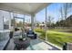 Cozy screened porch with comfortable seating, overlooking the backyard and lush landscaping at 1114 Donerail Ln, Johns Island, SC 29455