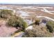 Aerial view of waterfront homes showcasing private docks, lush surroundings, and coastal living at 12 Trachelle Ln, Charleston, SC 29407