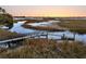 Marshfront dock at sunset offering incredible sunset views and access to boating at 12 Trachelle Ln, Charleston, SC 29407