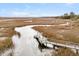 Aerial view showcasing the private dock access and the expansive marshland surrounding the property at 12 Trachelle Ln, Charleston, SC 29407