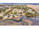 Panoramic aerial shot of waterfront homes with docks, surrounded by lush trees and estuary at 12 Trachelle Ln, Charleston, SC 29407