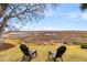 Lush backyard featuring chairs overlooking a serene marsh and waterway with wooden dock at 12 Trachelle Ln, Charleston, SC 29407