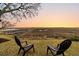 Backyard chairs look out over the marsh and waterway in the distance at sunset at 12 Trachelle Ln, Charleston, SC 29407