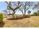 This grassy backyard features mature trees, with a view of the marsh and waterway at 12 Trachelle Ln, Charleston, SC 29407