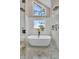 Bathroom showcasing a frameless shower, soaking tub, and views of the marsh at 12 Trachelle Ln, Charleston, SC 29407
